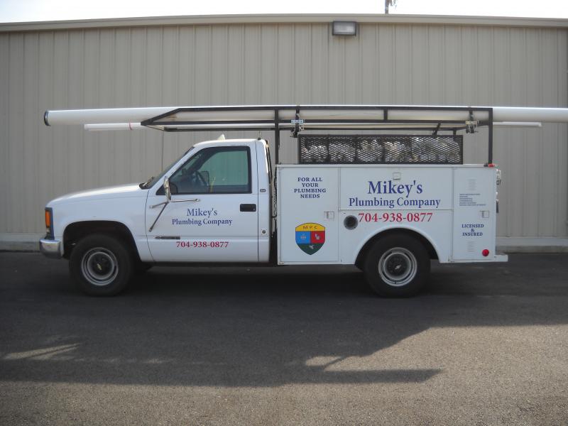 Mikey’s original plumbing service truck, with the full vehicle and pipe rack visible
